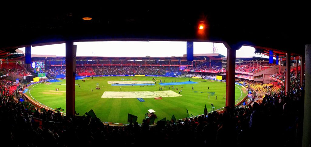 Floodlit cricket stadium packed with fans